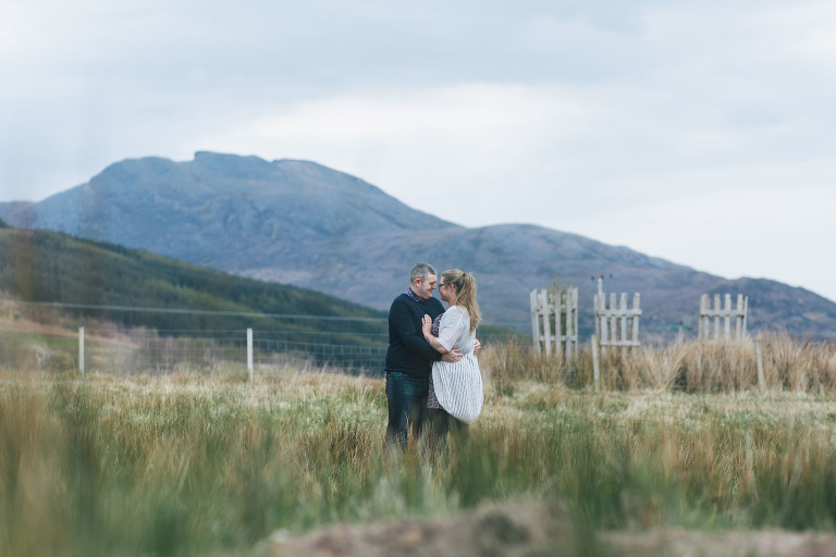 woman-man-embracing-couples-shoot-in-lochcarron-field