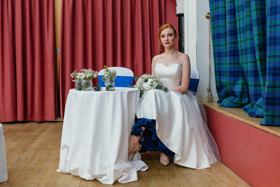 bride-sitting-signing-table