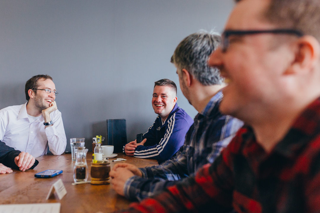 man-laughing-with-friends