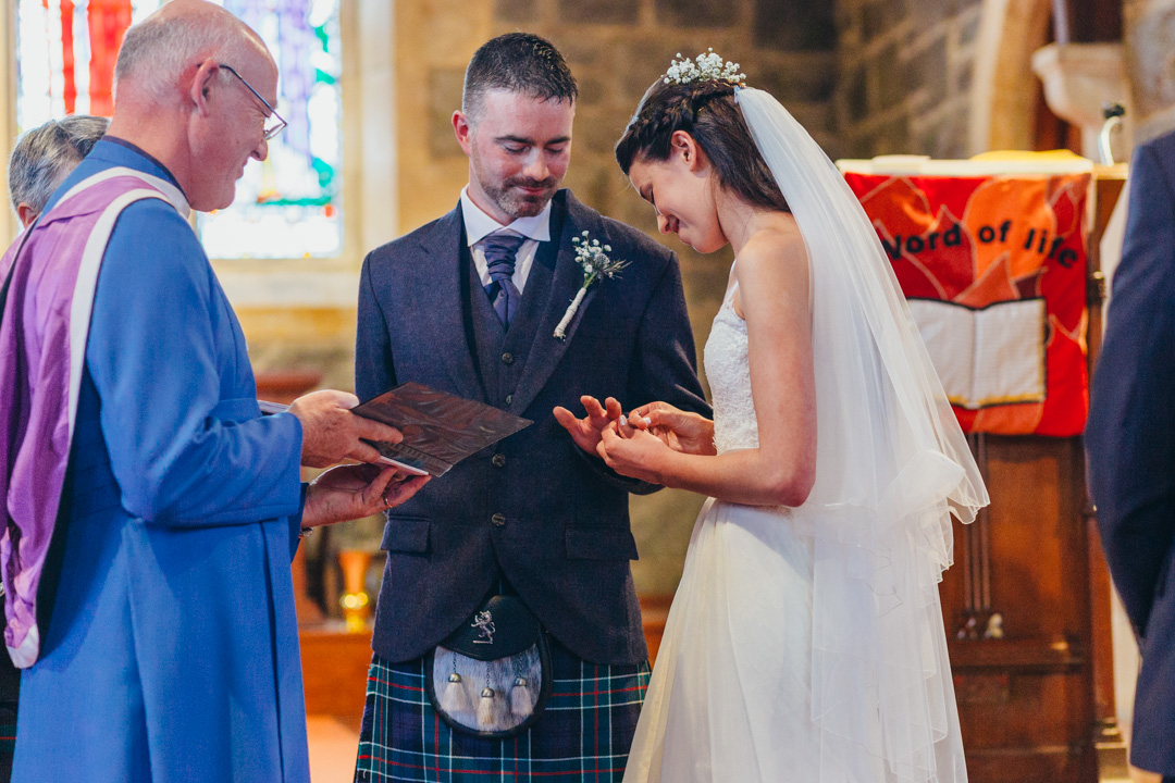 bride-giving-groom-wedding-ring