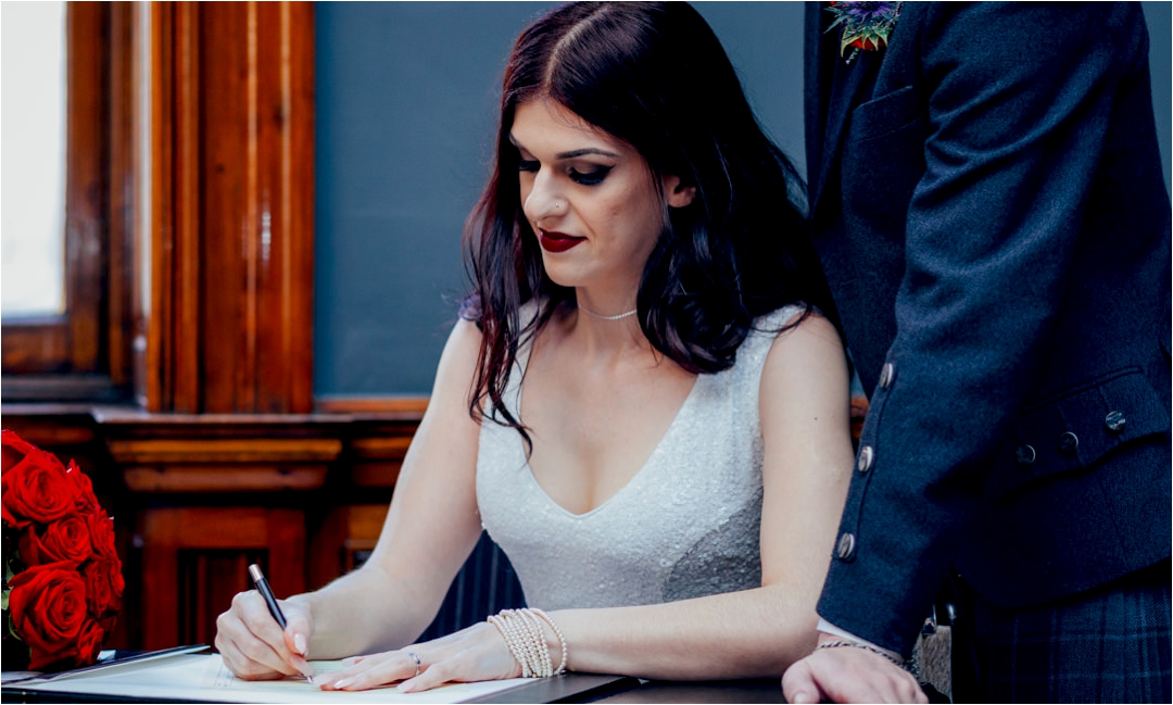 bride-signing-wedding-register