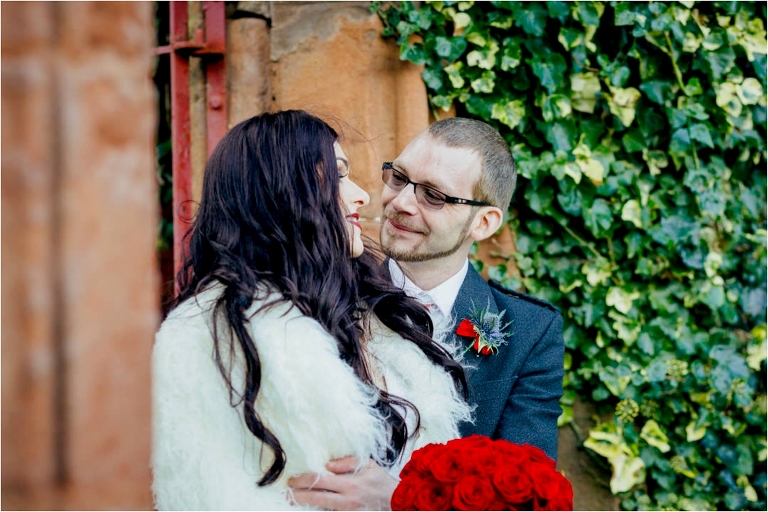 groom-smiling-at-wife-entrance-to-viewpark-gardens