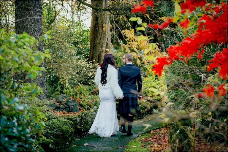 bride-groom-walking-through-garden