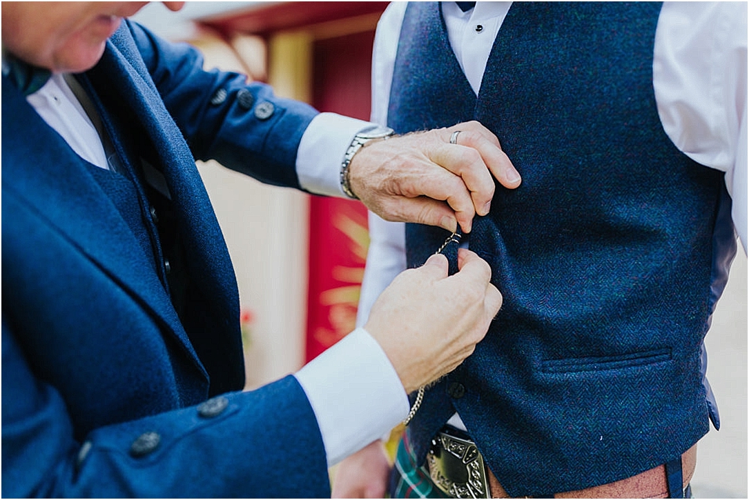 dad-helping-son-clip-pocket-watch-to-waist-coat