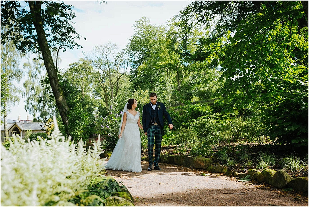bride-groom-walking-through-gardens