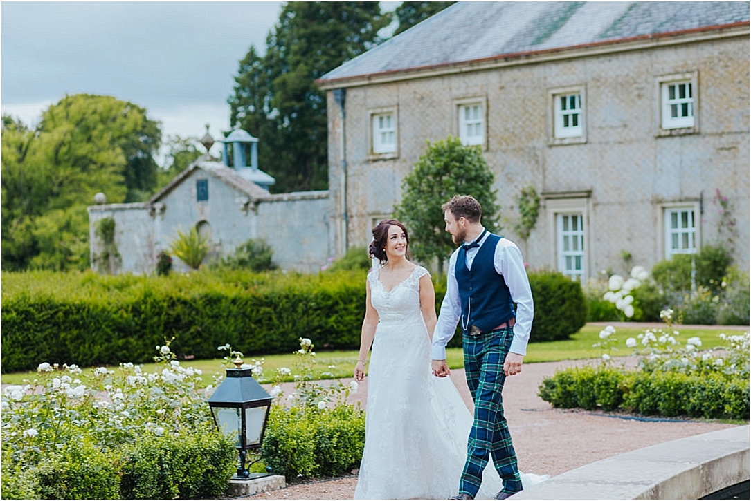 bride-groom-walking-outside-dumfries-house