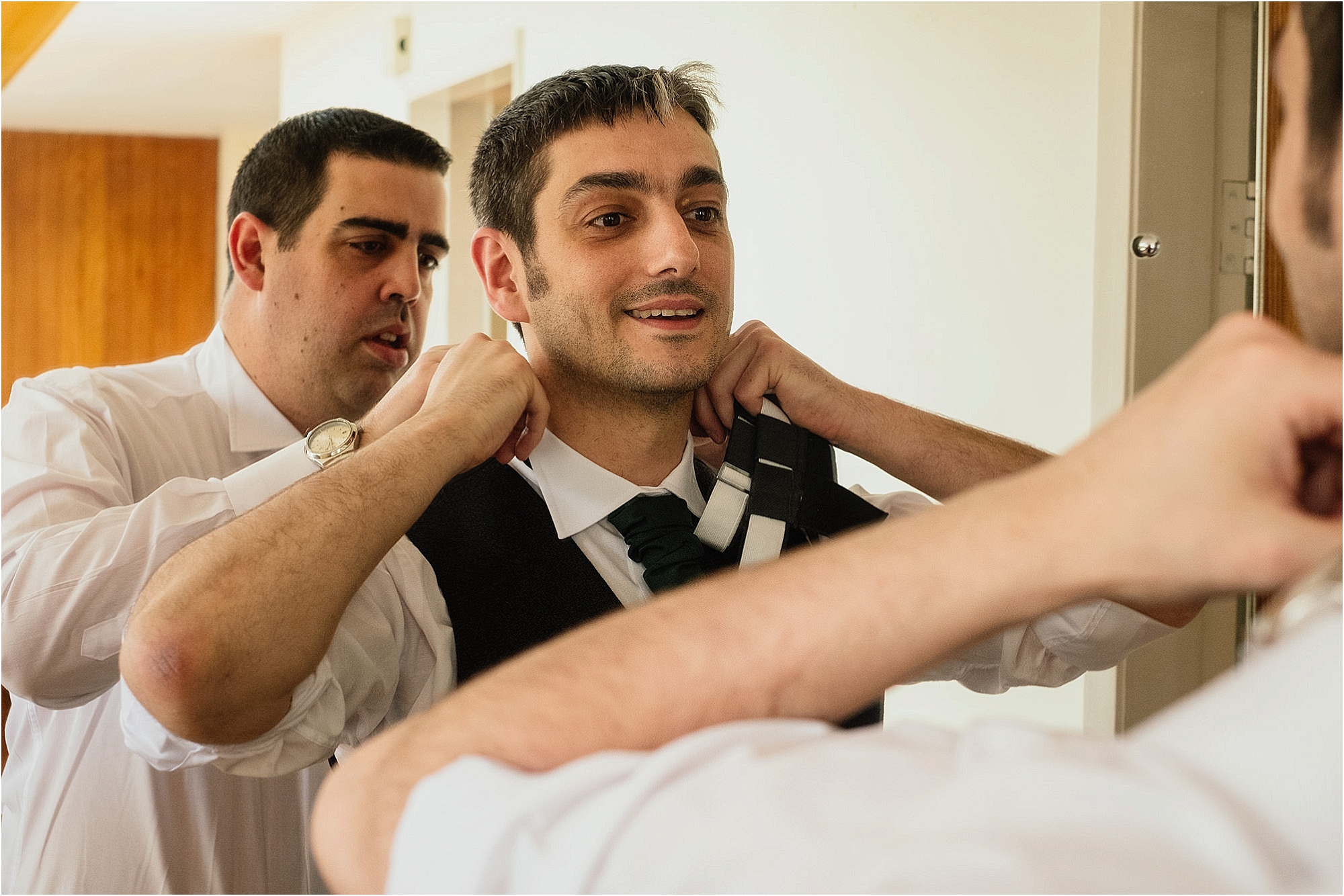 men-adjusting-collars-in-mirror