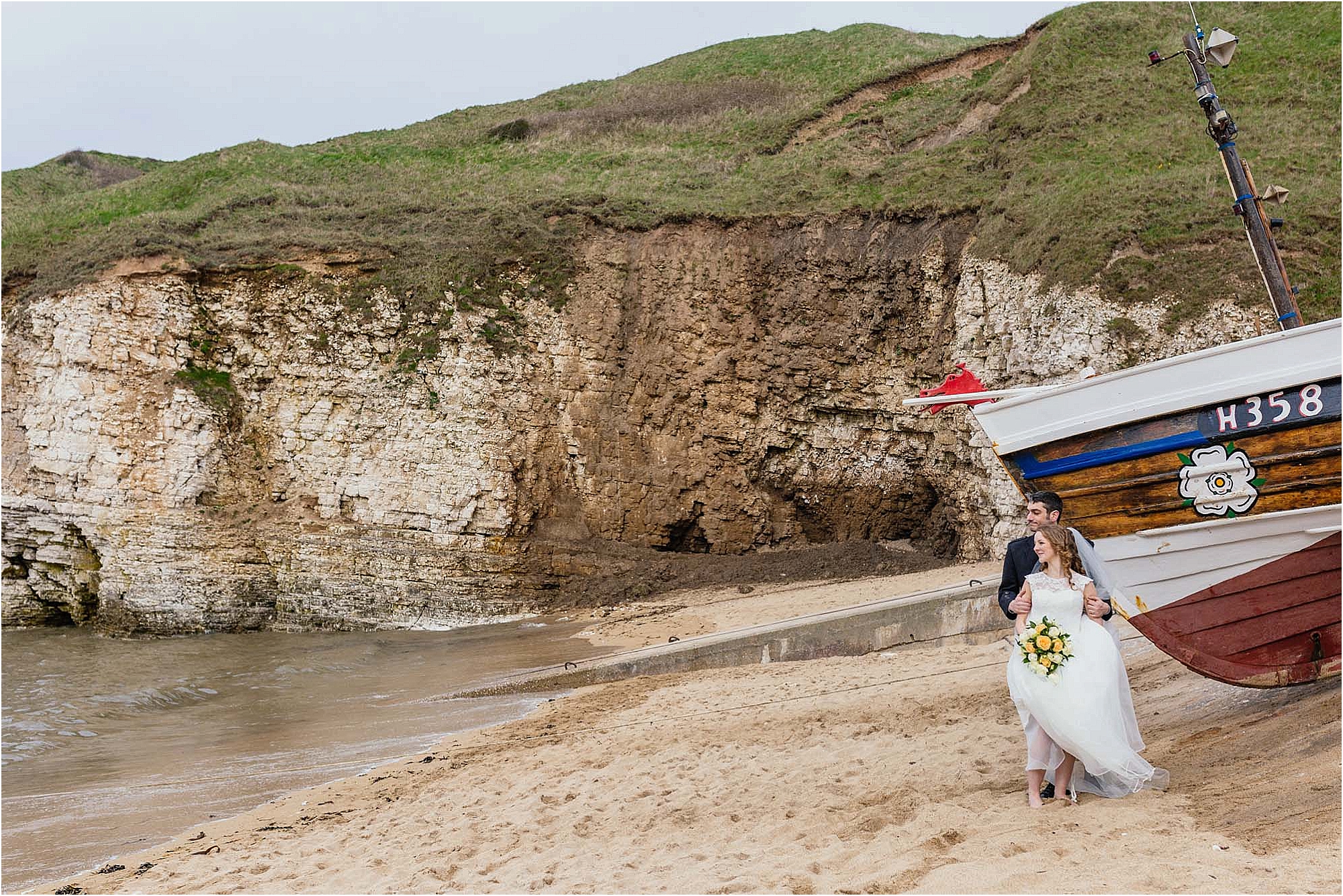 bride-groom-flamborough-beach-standing-by-boat