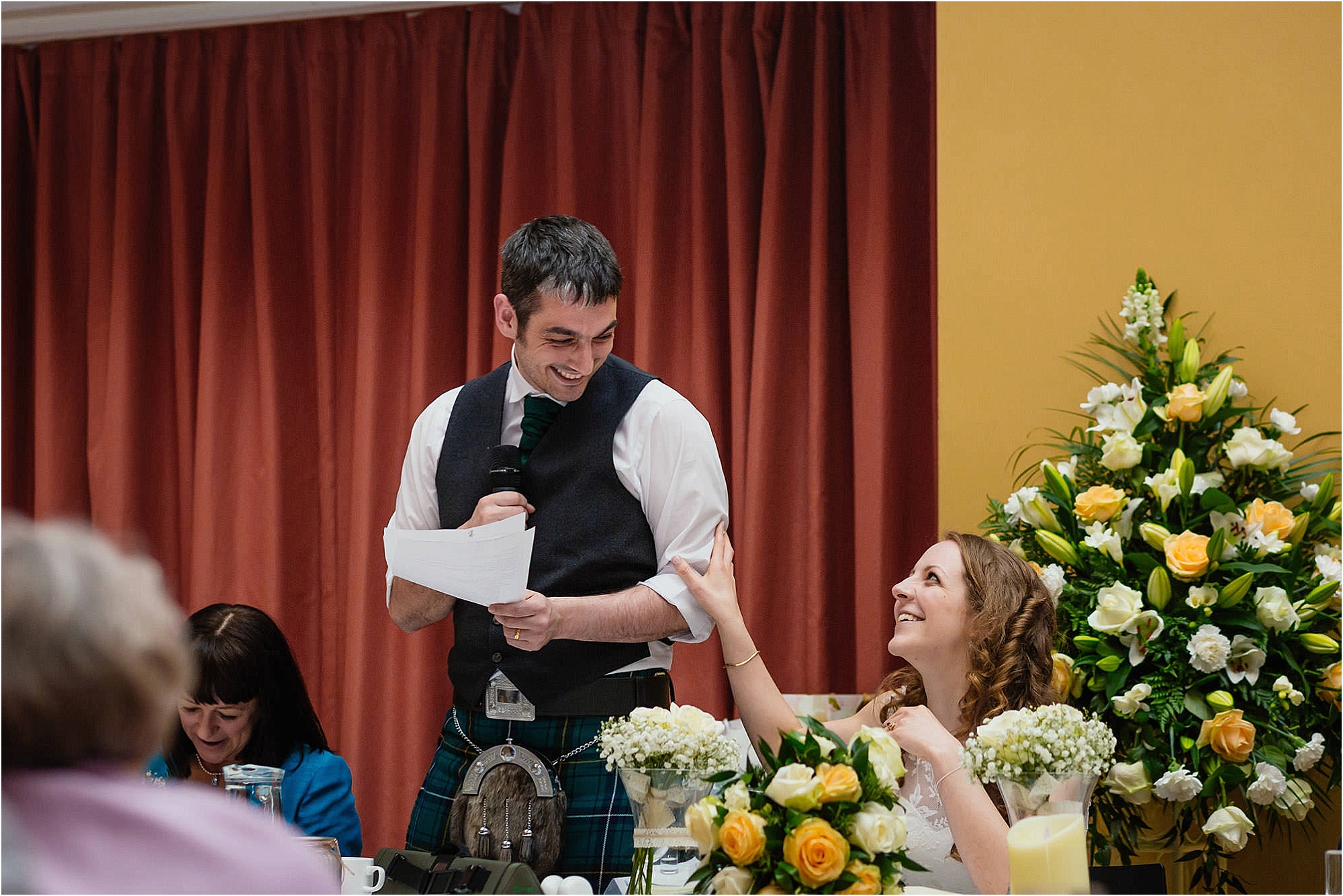 bride-groom-laughing-during-wedding-speech