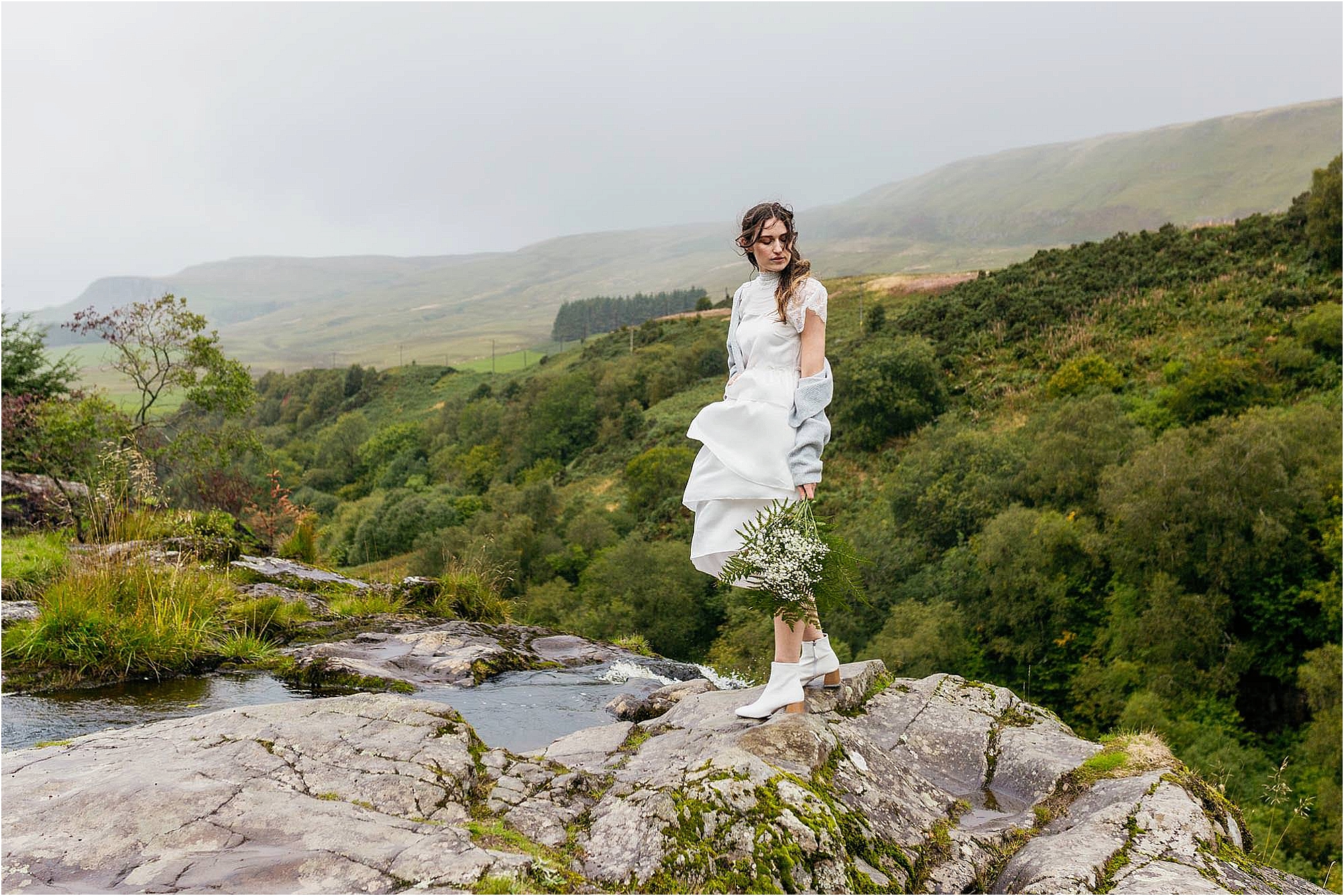 bride-standing-at-top-of-waterfall