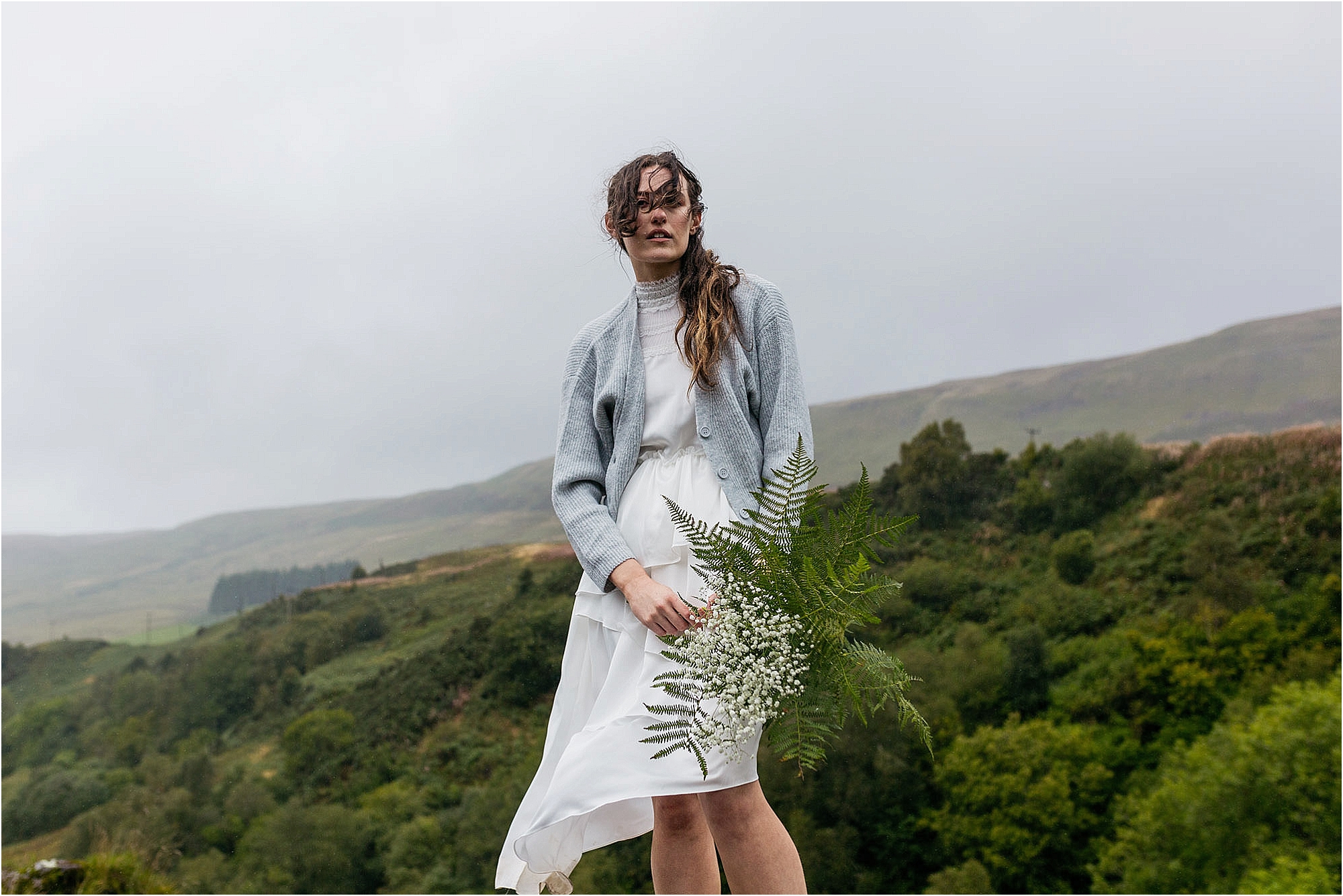model-standing-in-the-rain-with-bouquet