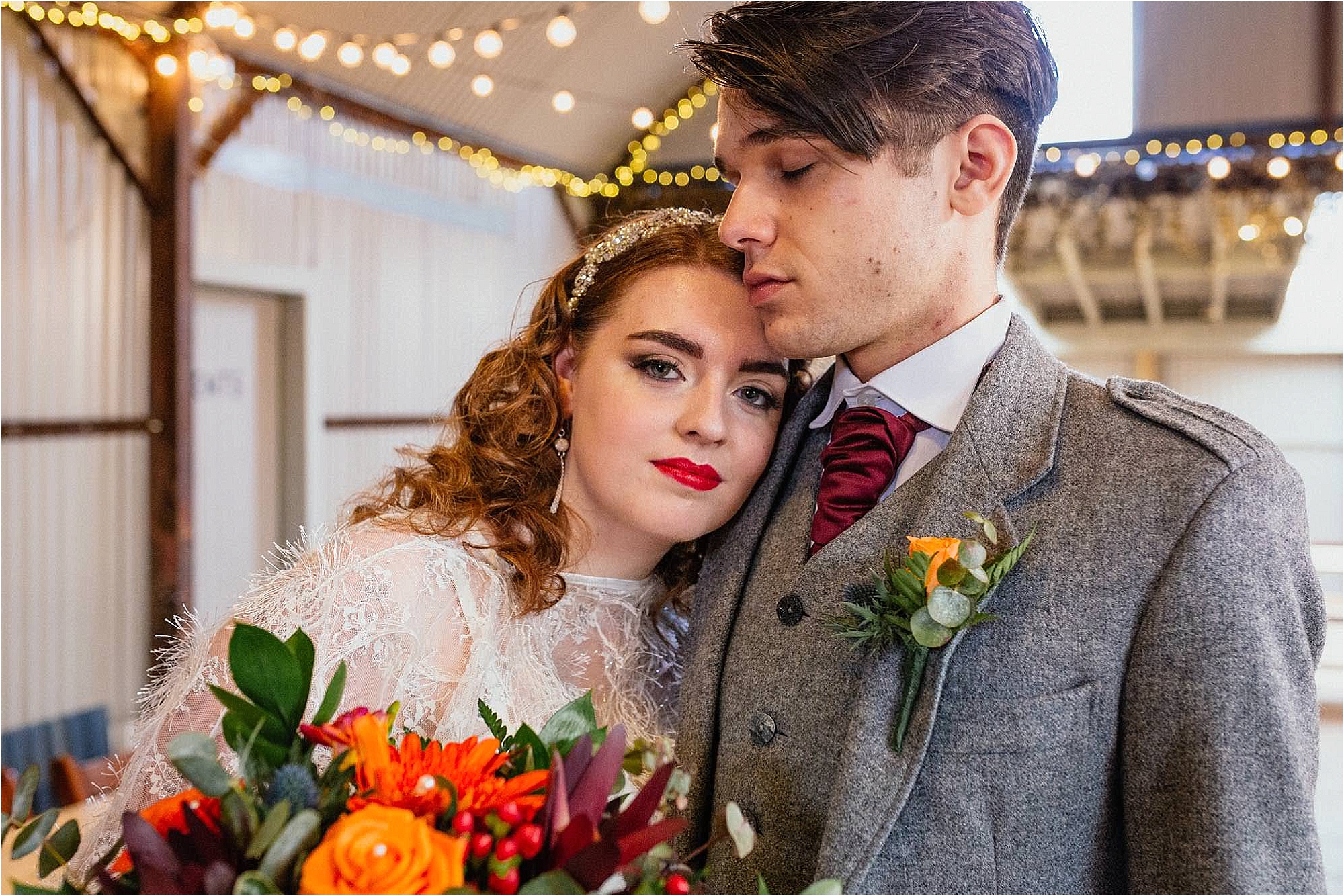 bride-looking-into-camera-hugging-groom