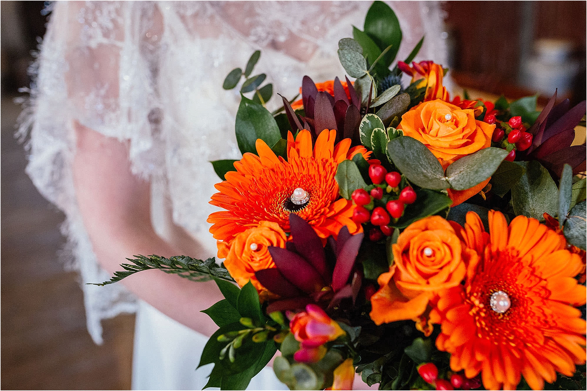 close-up-bridal-bouquet-with-orange-maroon-berries-flowers