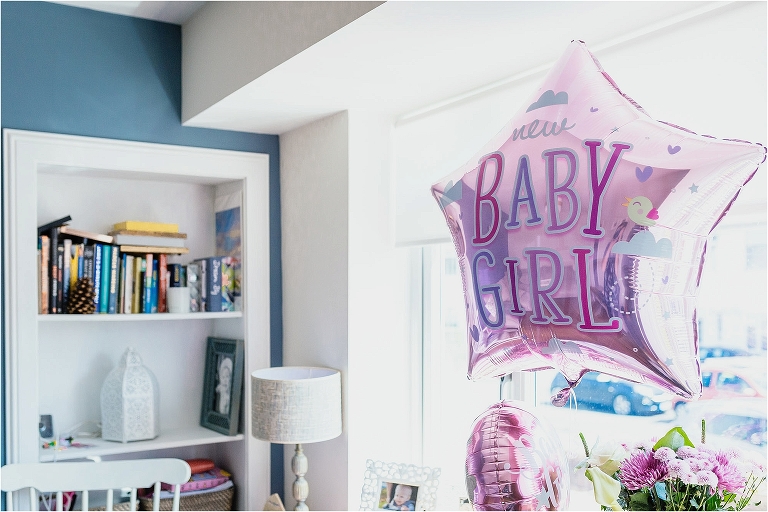 pink-baby-girl-balloon-floating-in-living-room