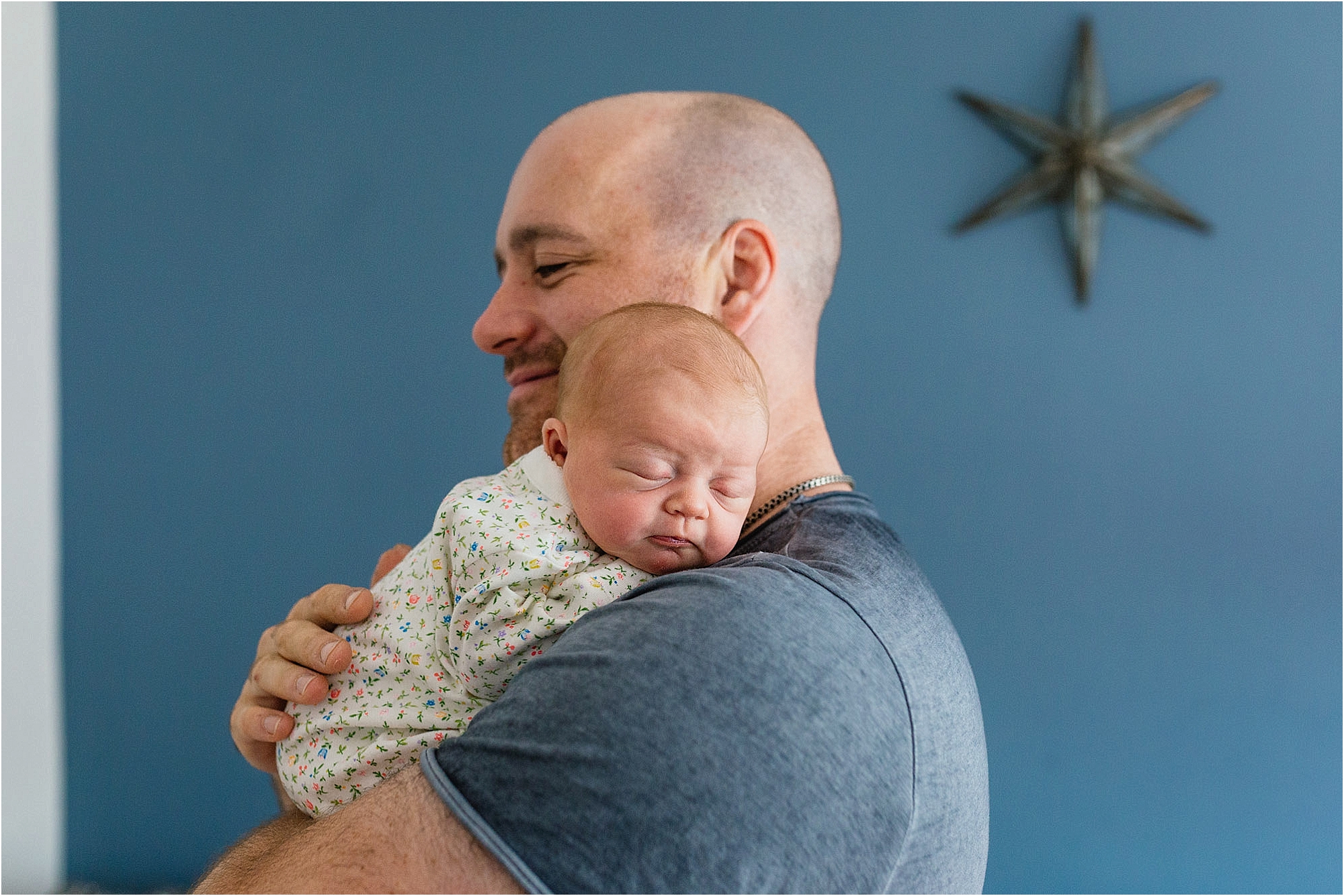 dad-cuddling-newborn-daughter