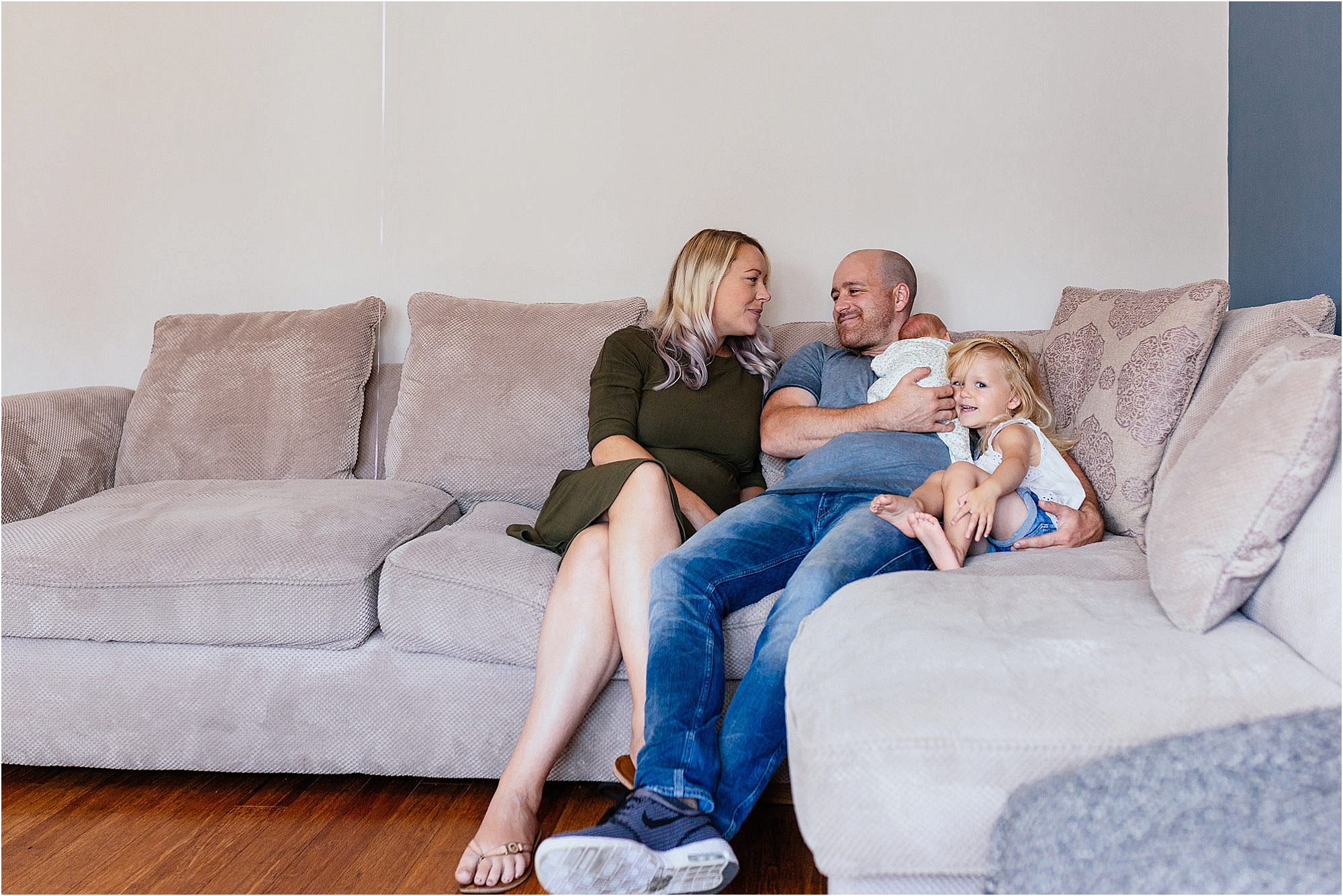 family-sitting-together-on-sofa