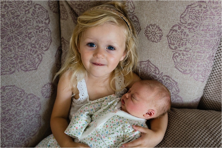 little-girl-holding-baby-sister