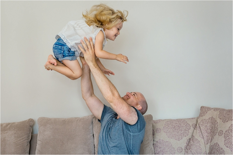 dad-throwing-daughter-lovingly-into-the-air