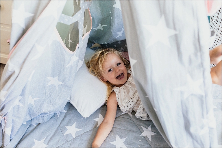 girl-laughing-in-indoor-teepee-tent