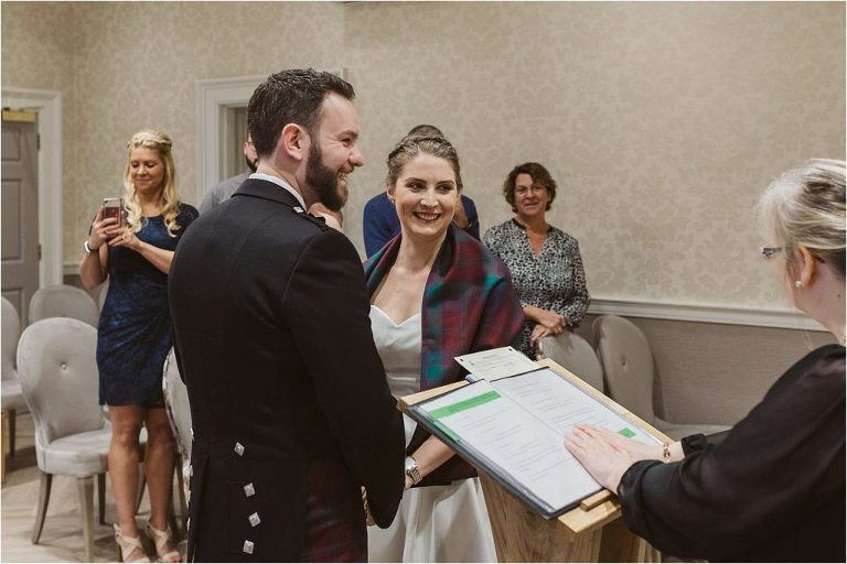 bride-and-groom-smile-as-they-are-getting-married