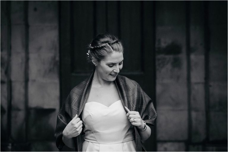 black-and-white-photo-of-bride-adjusting-shawl