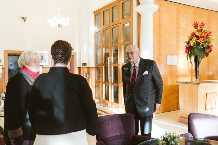 grooms-parents-greeting-bride-in-hotel-lobby