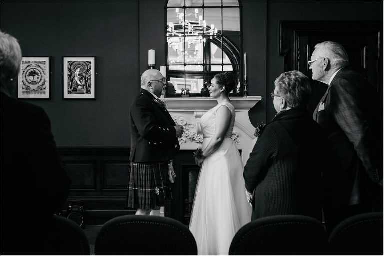 black-and-white-image-of-bride-and-groom-exchanging-vows