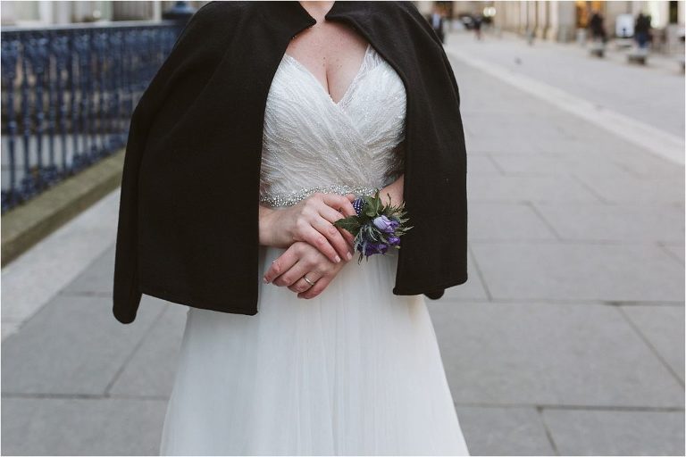 close-up-of-bride-purple-flower-wrist-corsage