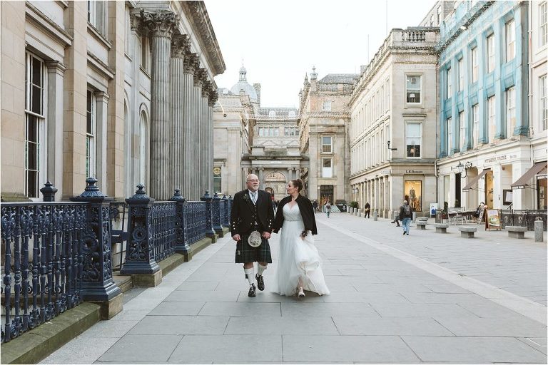 bride-and-groom-walking-through-merchant-square-glasgow