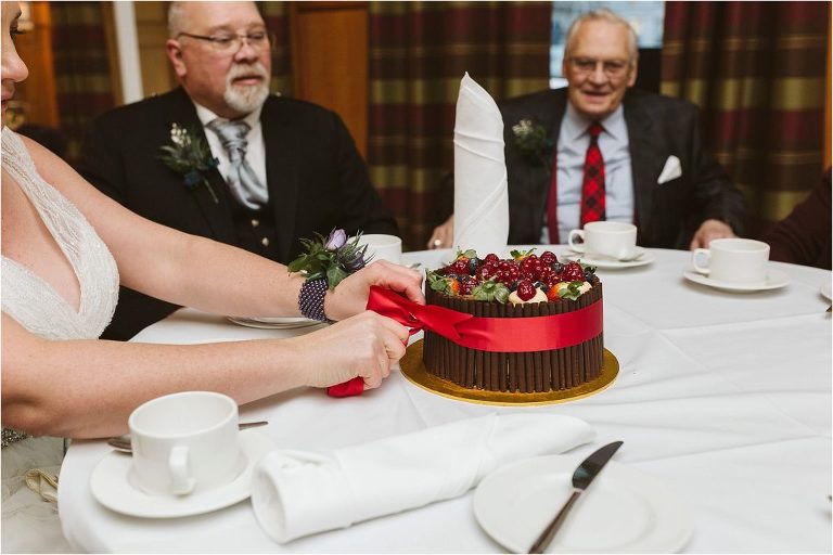 patisserie-valerie-cake-red-ribbon-and-decorated-with-strawberries-cranberries