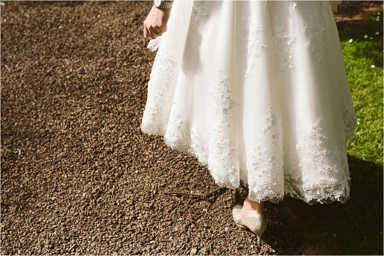 detail-photo-of-brides-dress-hem-as-she-walks-away