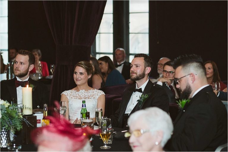 bride-and-groom-listen-as-father-of-the-bride-gives-speech
