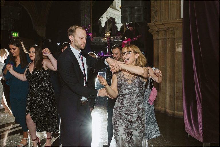 guests-laugh-as-they-dance-at-wedding-reception