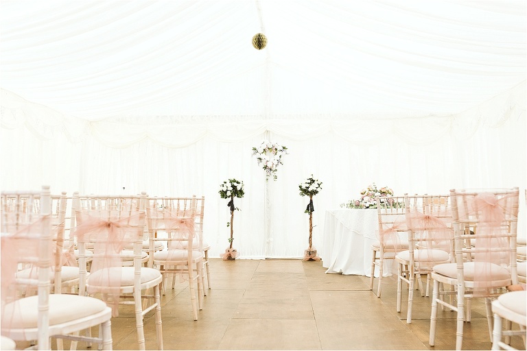 marquee-decorated-for-wedding-ceremony-blush-seat-sashes