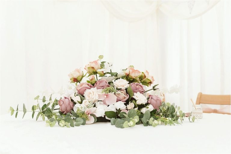 faux-flower-arrangement-of-roses-eucalyptus