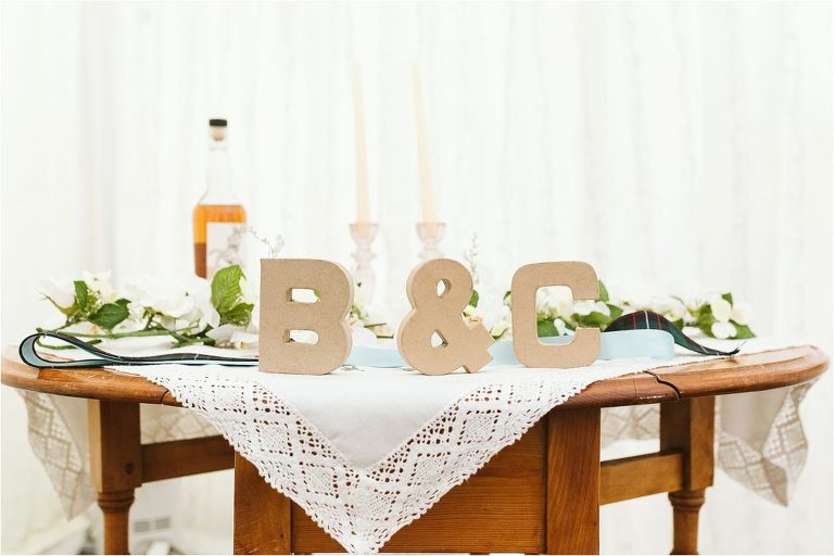 cardboard-initials-of-bride-and-grooms-names-with-vintage-tablecloth