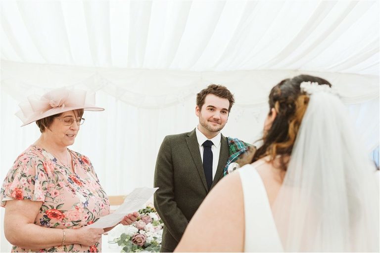 groom-smiles-at-bride