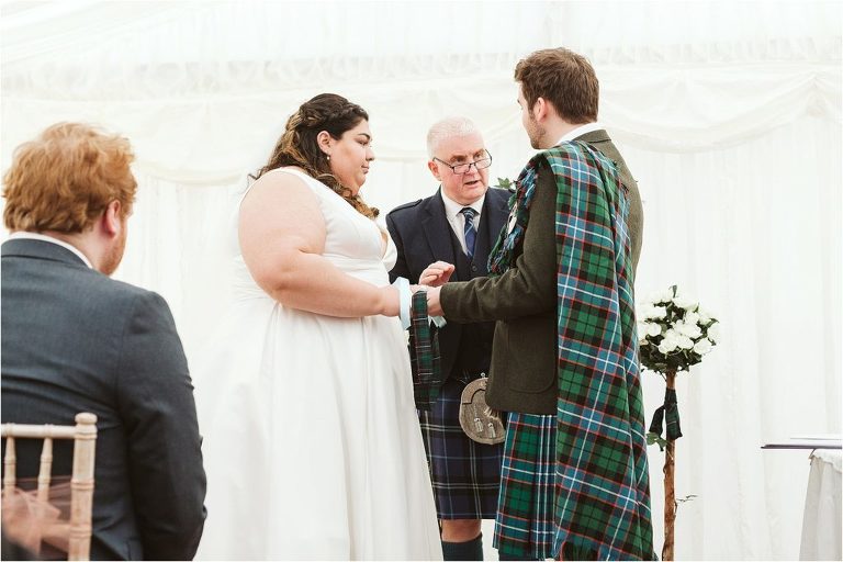 bride-and-groom-carry-out-handfasting-during-ceremony