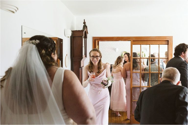 bridesmaid-walking-towards-bride