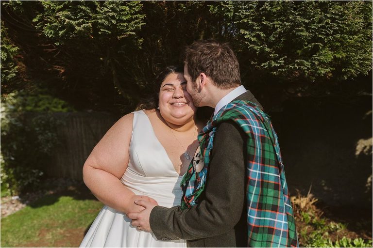 groom-kisses-brides-cheek