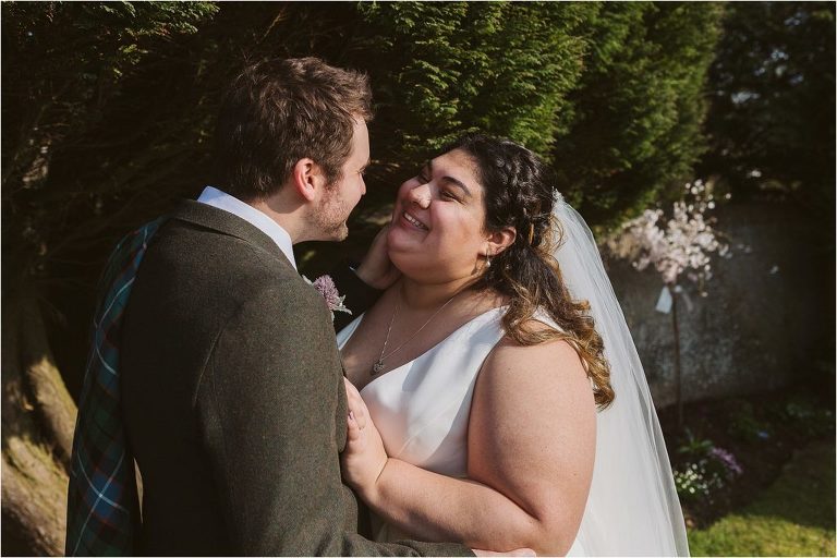 bride-smiles-as-groom-touches-her-face