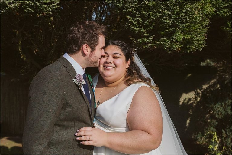 groom-kisses-brides-cheek