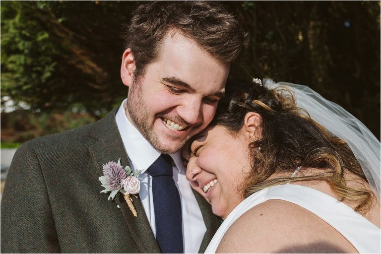 groom-and-bride-smiles-as-they-hug-each-other