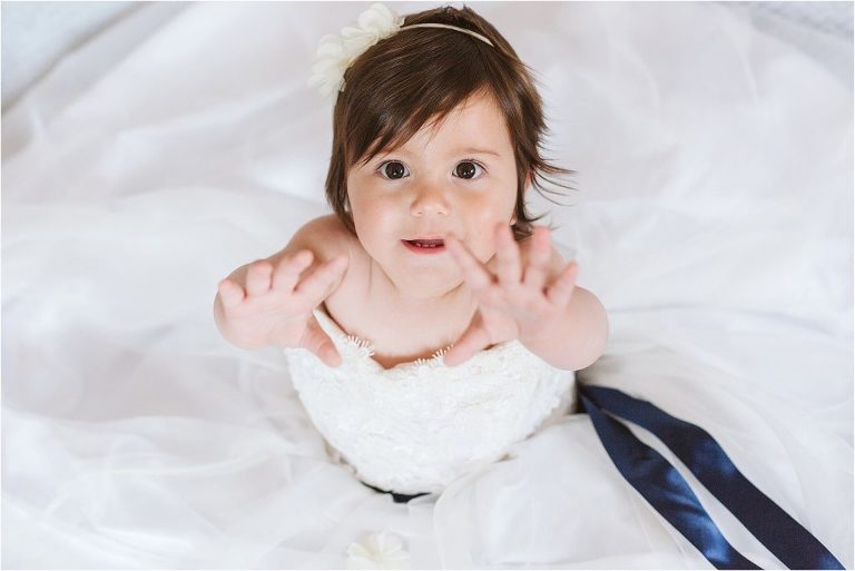 little-girl-lifting-arms-up-towards-camera