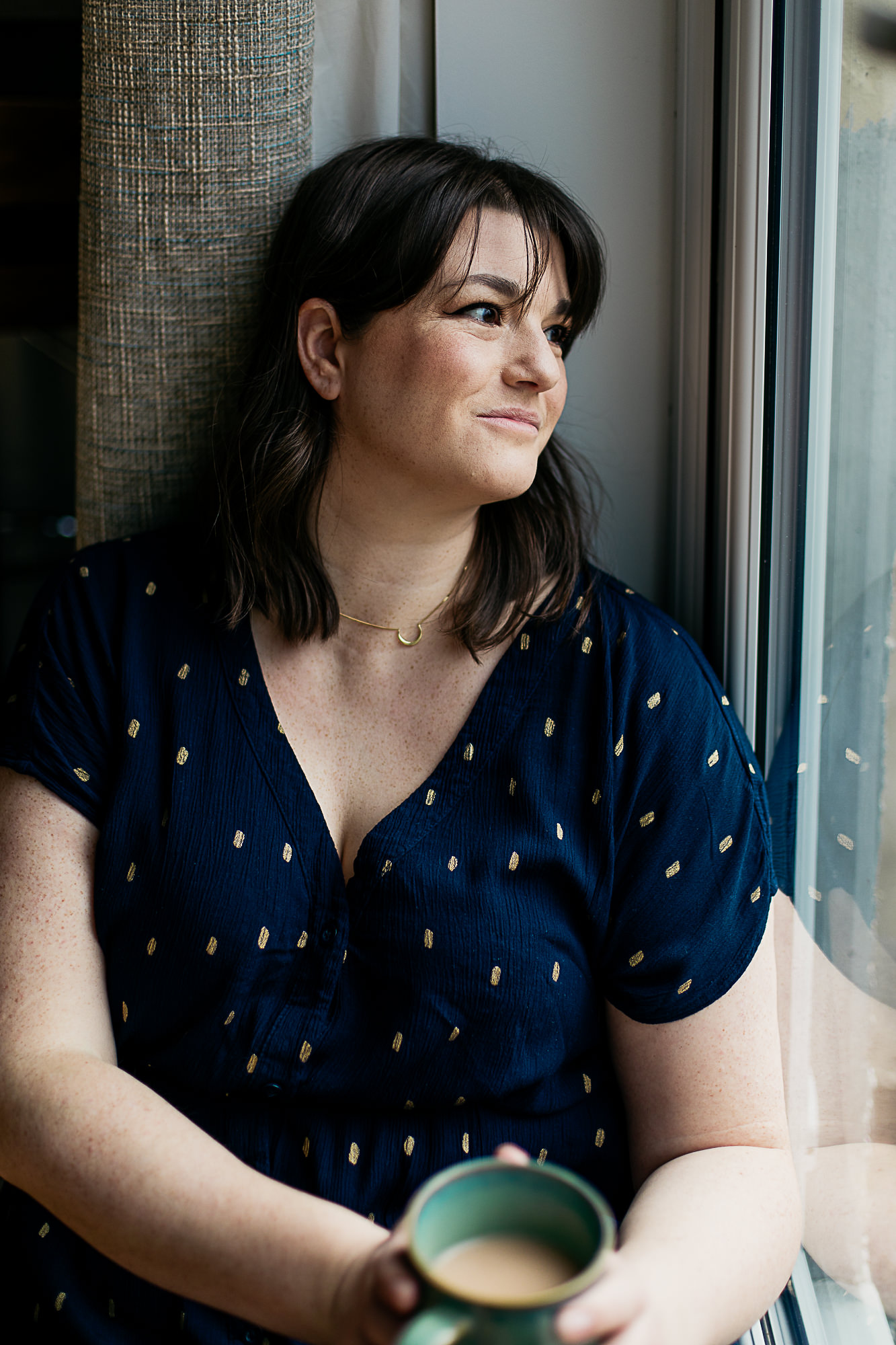 woman-smiling-while-looking-out-the-window