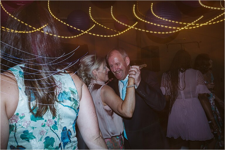 two-guests-dancing-at-wedding-reception-light-trails