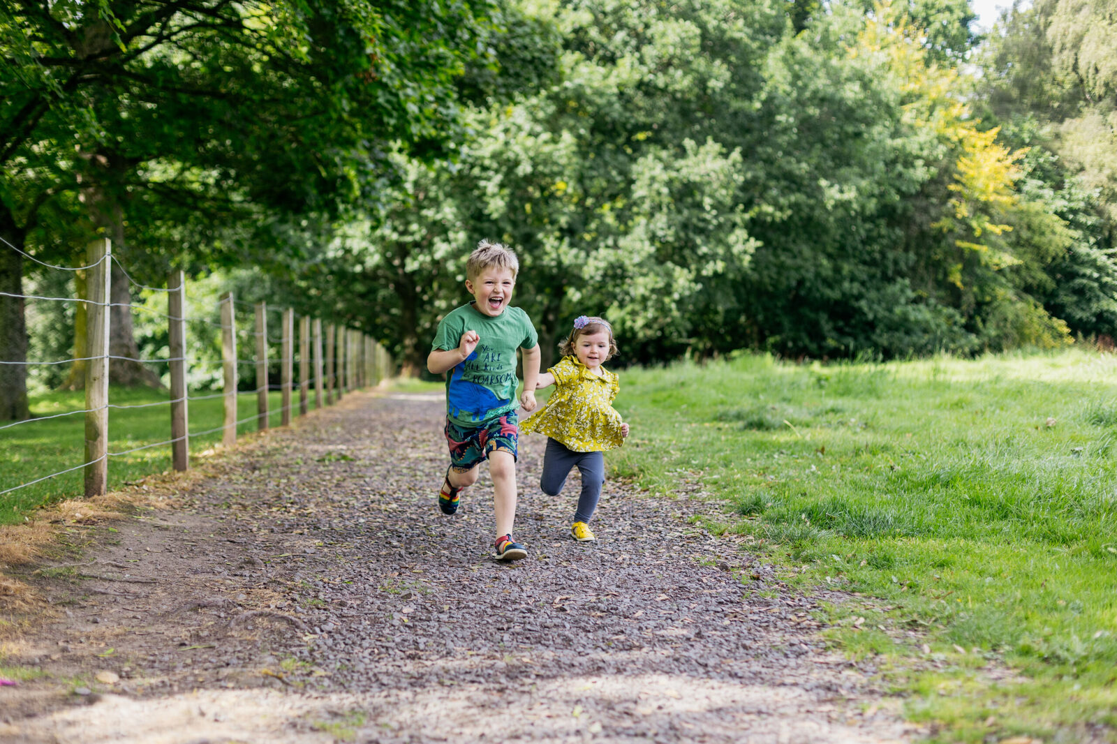 boy-and-girl-running-along-a-path-in-the-park