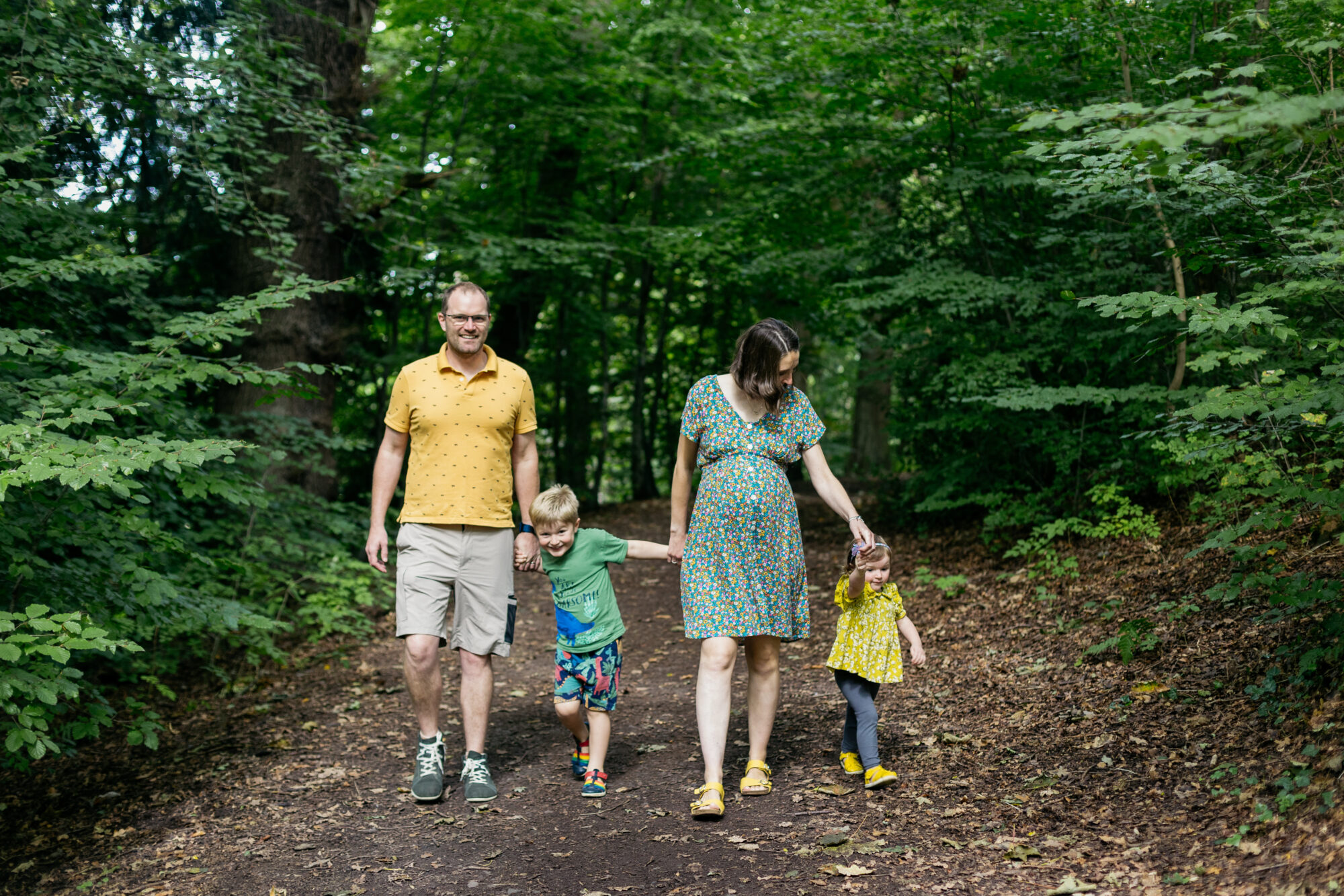 mum-and-dad-walking-hand-in-hand-through-the-woods