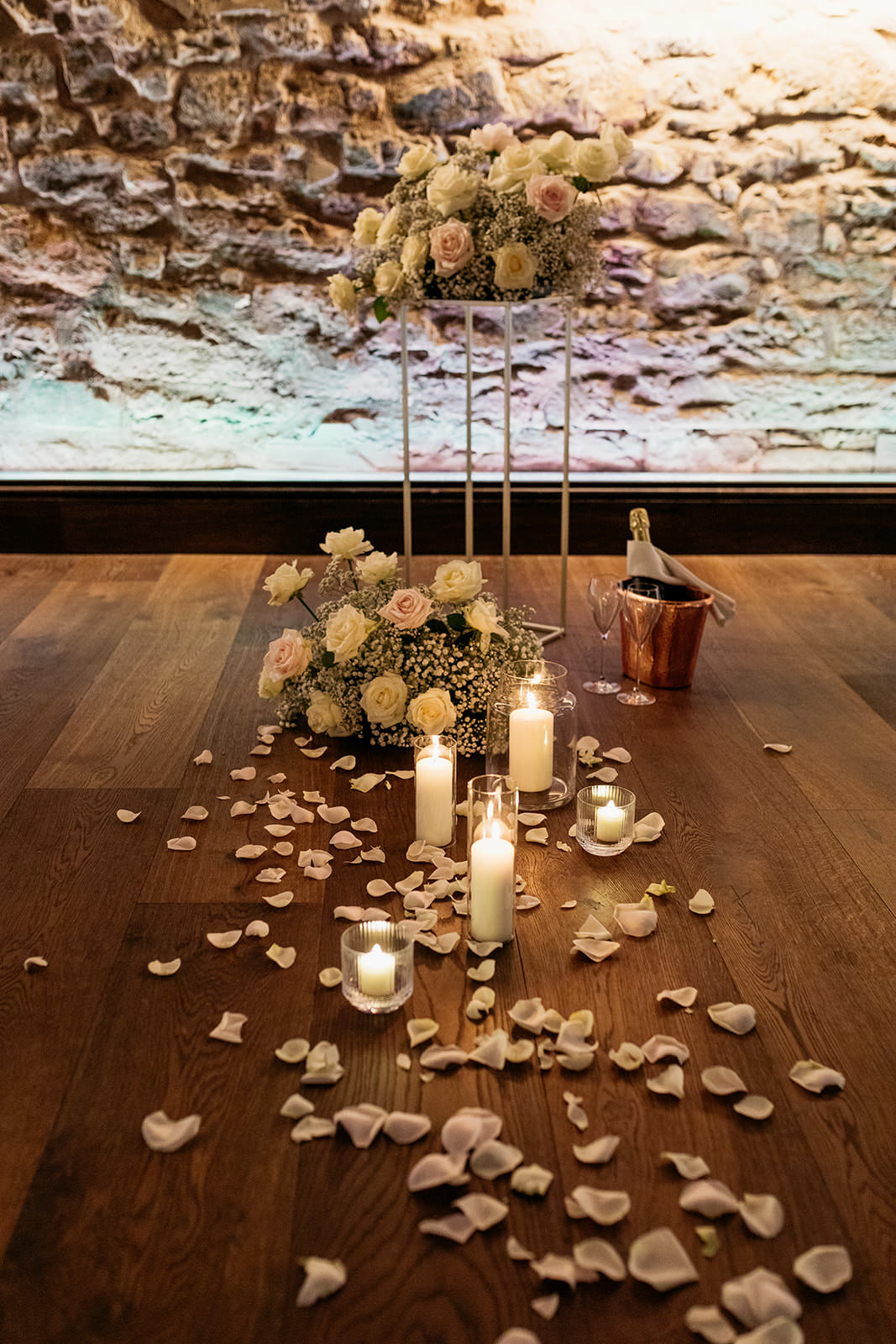 picture-of-lit-candles-and-rose-petals-on-the-floor-there-are-bouquets-of-white-and-pink-roses