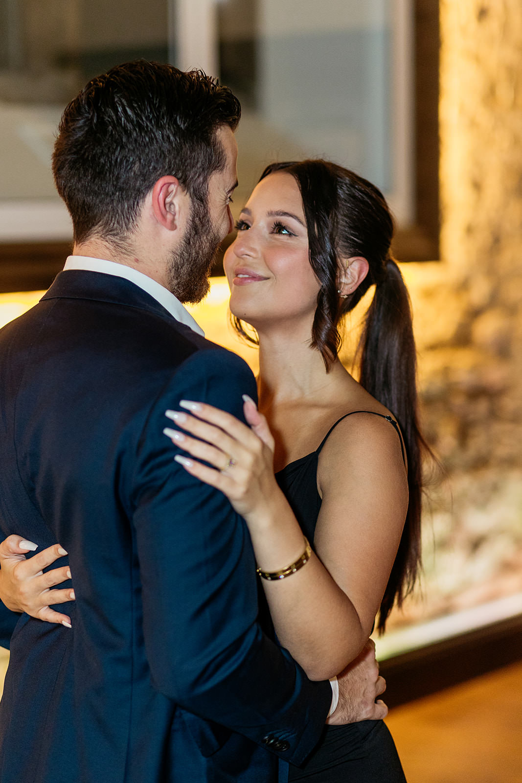 woman-looks-at-her-partner-and-is-smiling-while-they-hold-each-other